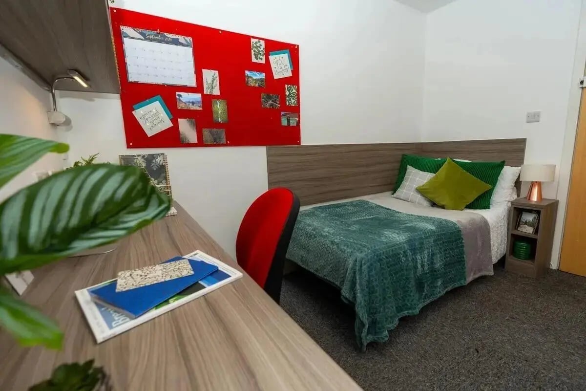 Bed desk chair bulletin board bedroom at Tramways - Salford in Salford Student Accommodation