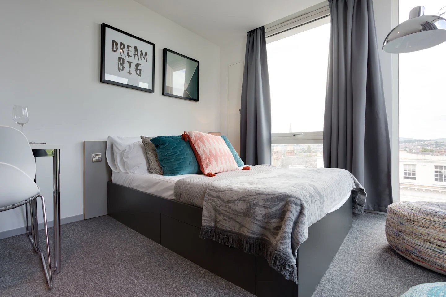 Bed with pillows and framed art bedroom at Queen Street Studios in Exeter Student Accommodation