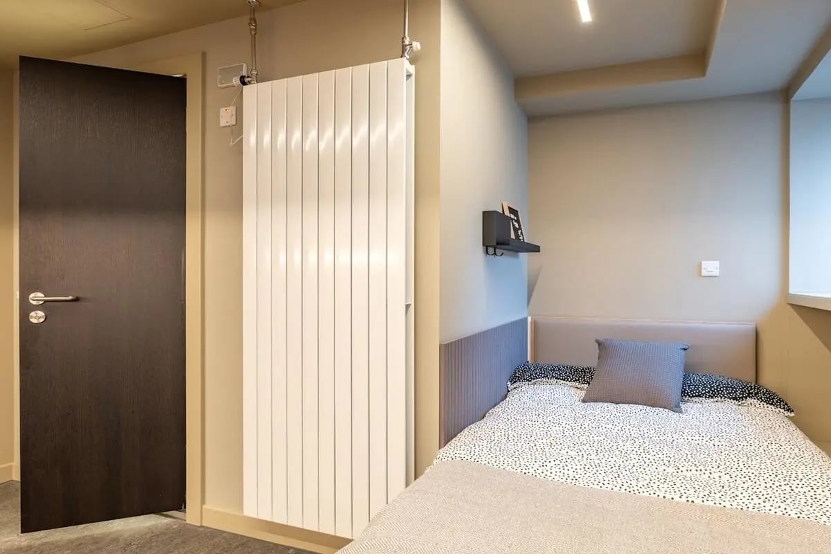 Bed with grey pillow and spotted duvet bedroom at Potterrow in Edinburgh Student Accommodation