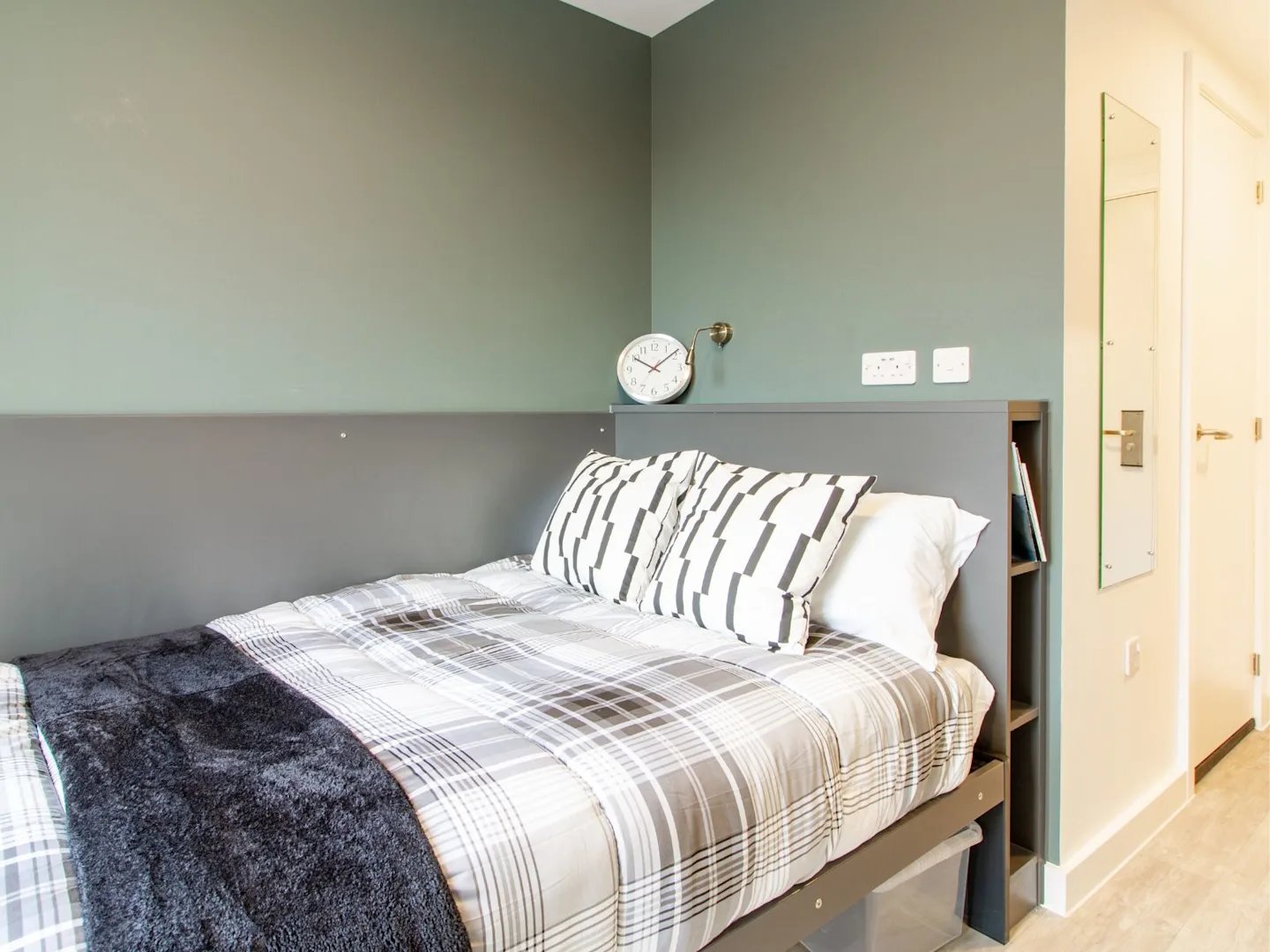 Bed pillows headboard clock and shelves bedroom at Benedict's Gate in Norwich Student Accommodation