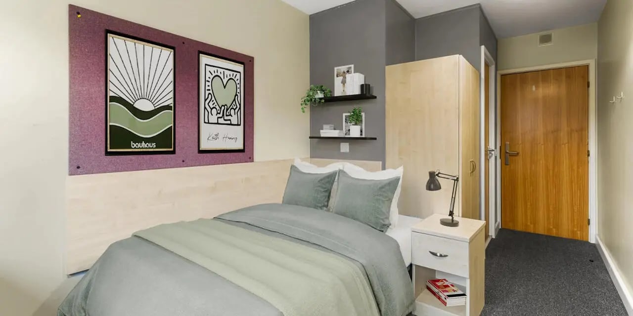 Bed nightstand lamp artwork wardrobe door bedroom at The Heights in Birmingham Student Accommodation