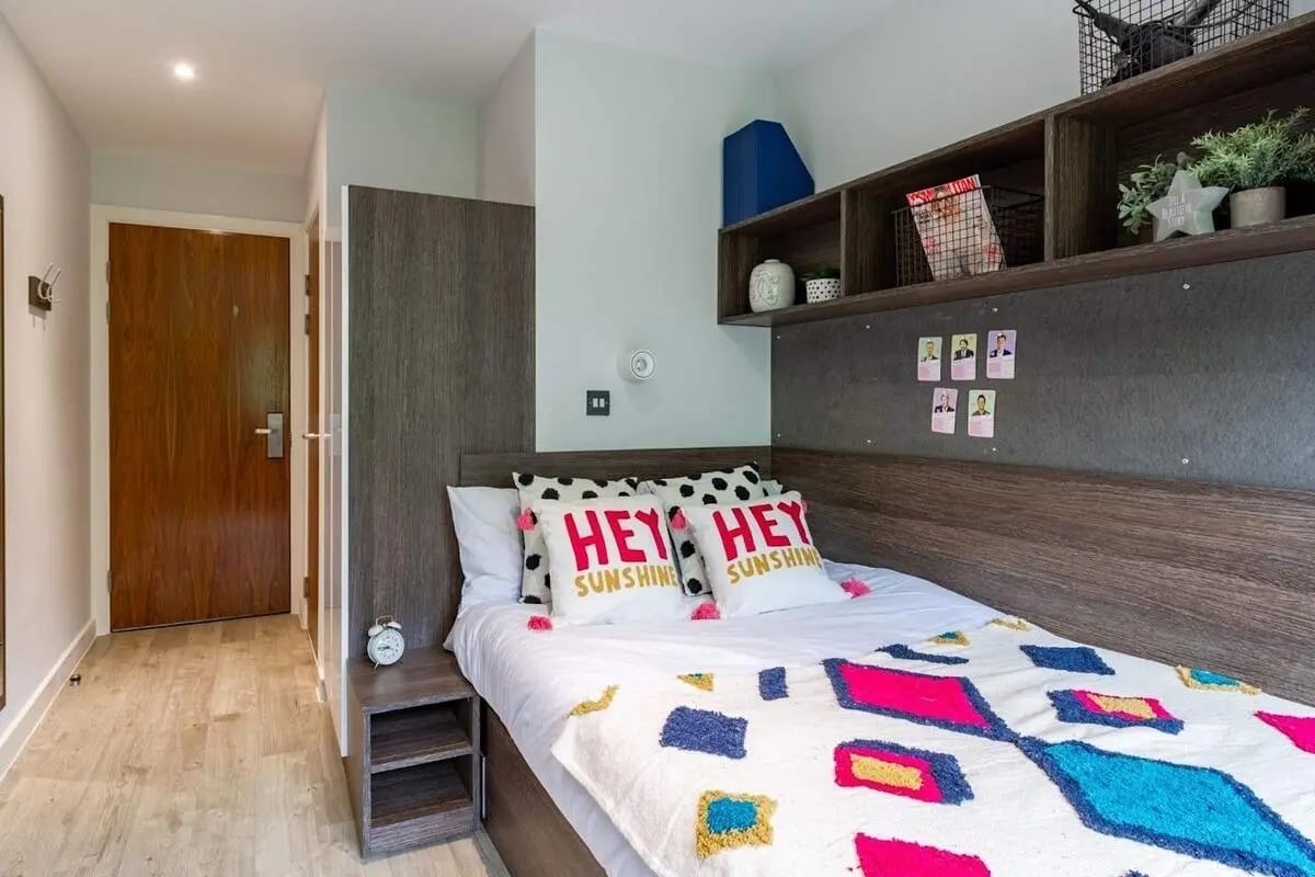 Bed with colorful blanket and pillows bedroom at Cricket Field Court in Exeter Student Accommodation