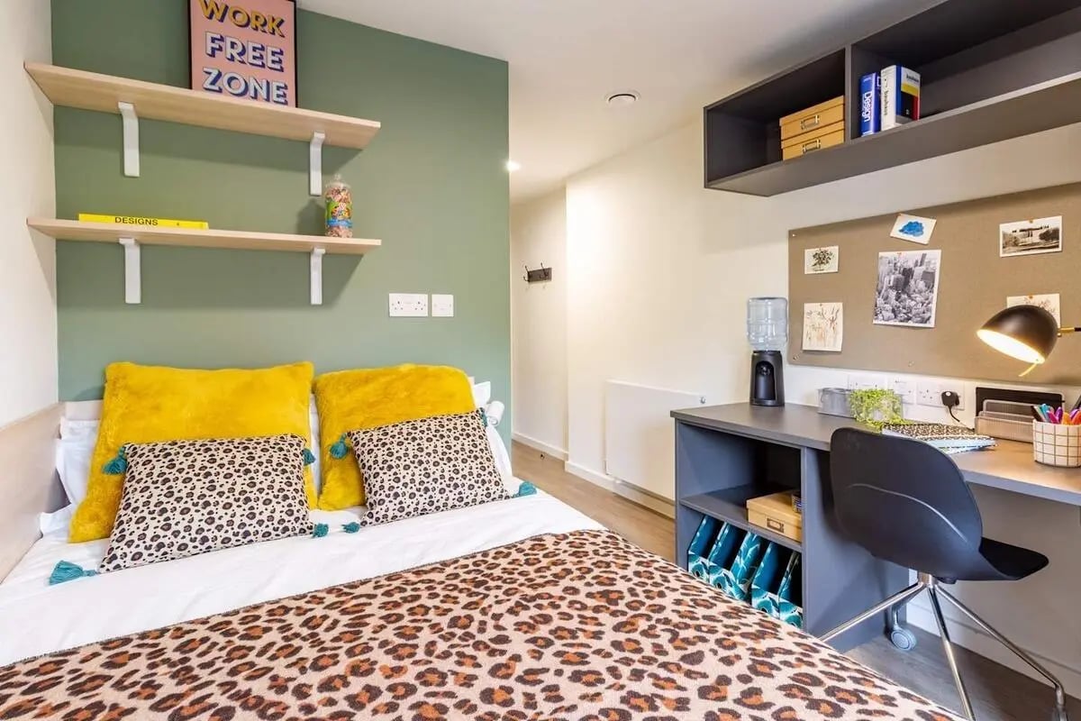 Bed desk shelves water dispenser bedroom at Dun Holm House in Glasgow Student Accommodation