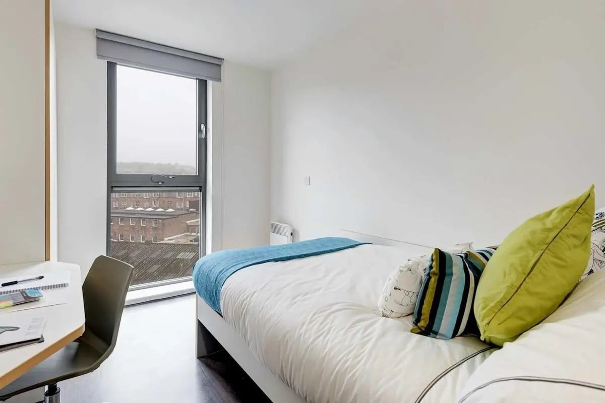 Bed desk chair and window view bedroom at Dunaskin Mill in Glasgow Student Accommodation