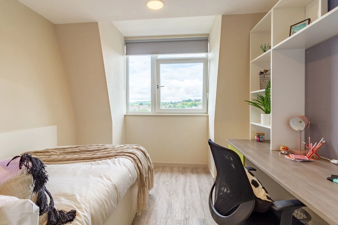 Bed desk shelving with plants lamp bedroom at The Barn in Exeter Student Accommodation