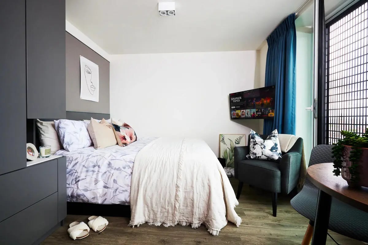 Bed with pillows wardrobe and chair bedroom at Vita Student Manchester Circle Square in Manchester Student Accommodation