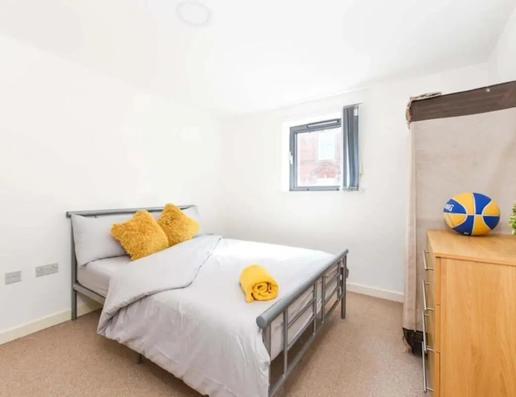 Bed with yellow pillows basketball chest of drawers bedroom at Mellor House - Central Place in Sheffield Student Accommodation