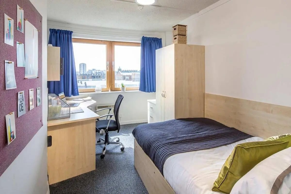 Desk chair bed wardrobe window view bedroom at New Orient House in London Student Accommodation
