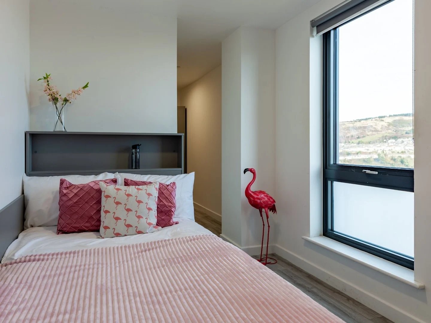 Bed with pink flamingo pillows and duvet bedroom at The Oldway Centre in Swansea Student Accommodation