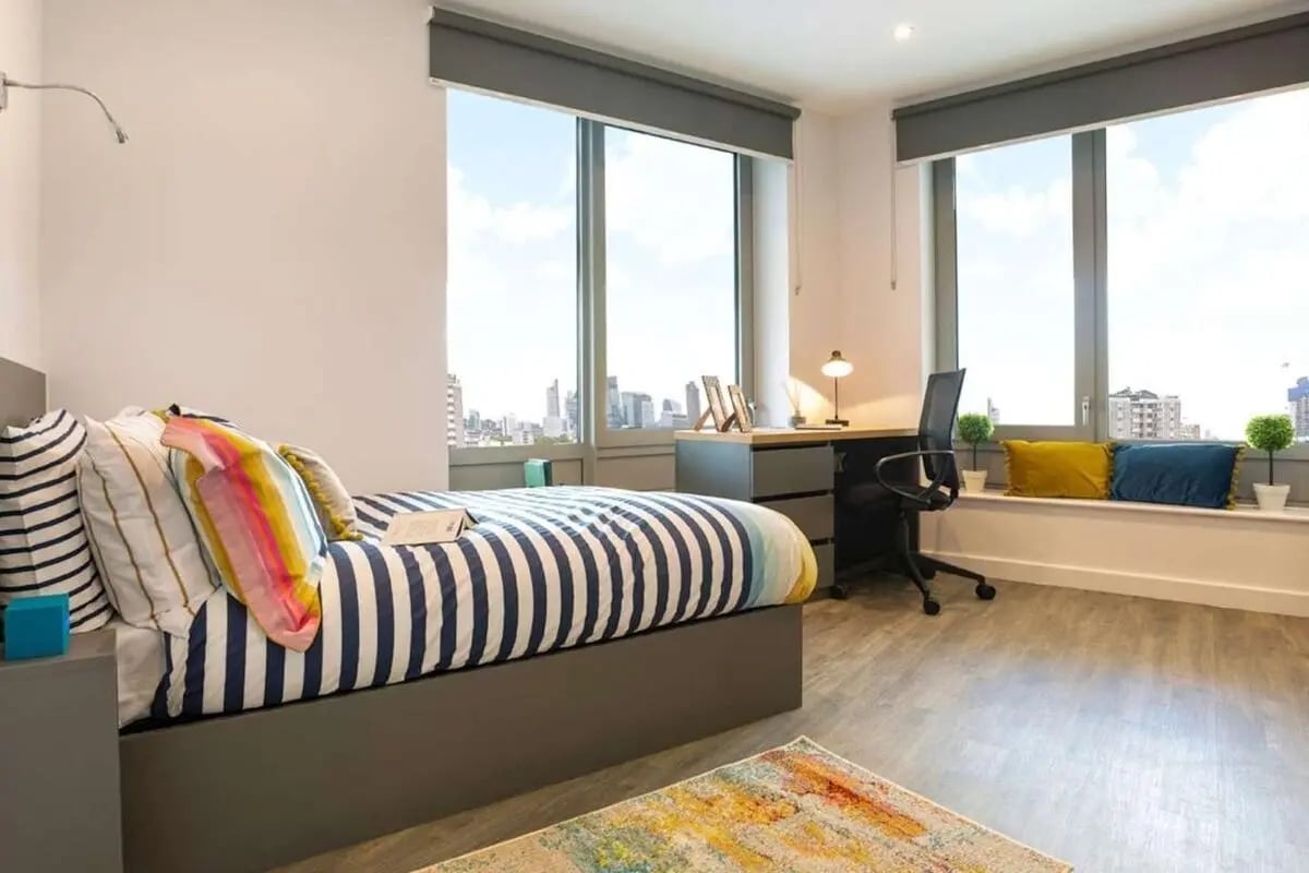 Bed desk chair large window city view bedroom at Great Court in London Student Accommodation