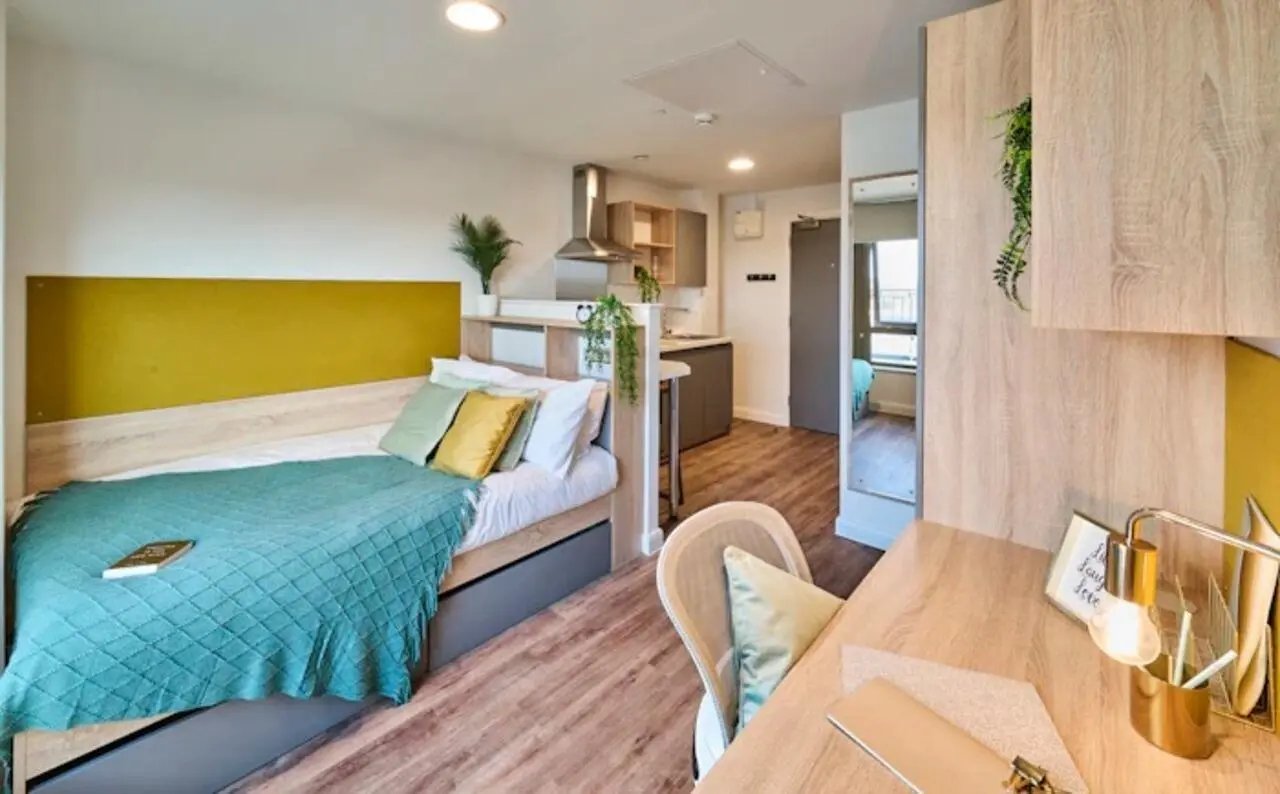 Bed desk kitchen and a small hallway bedroom at Deakins Place in Nottingham Student Accommodation