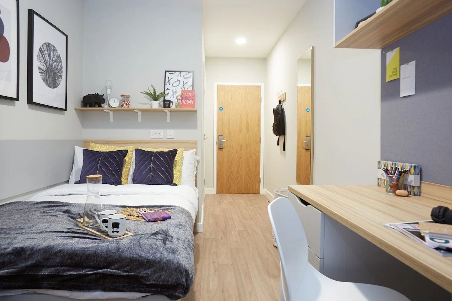Bed with grey throw pillows and desk Bedroom at Gulson Gardens in Coventry Student Accommodation
