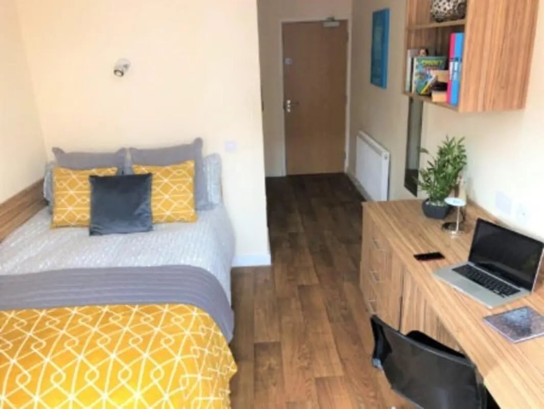 Bed desk laptop and chair student bedroom at Waterside Court in Chester Student Accommodation