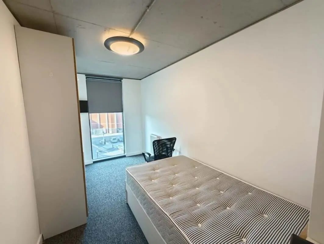 Bed wardrobe and chair student bedroom at London court in Sheffield Student Accommodation