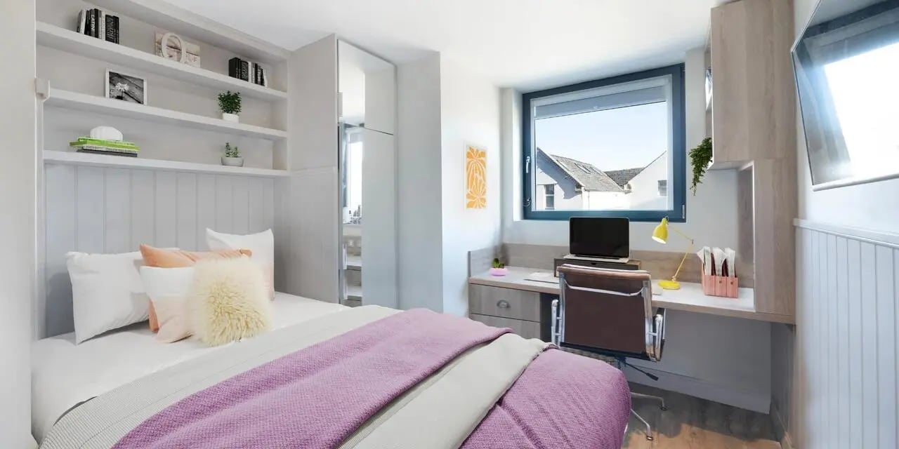 Bed desk with laptop and chair bedroom at Canvas The Parade in Cardiff Student Accommodation