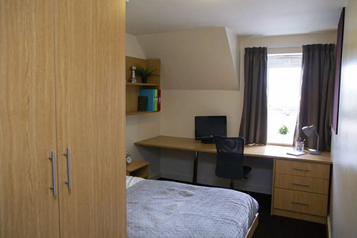 Wardrobe bed desk computer chair bookshelf bedroom at Foundry 1 in Loughborough Student Accommodation