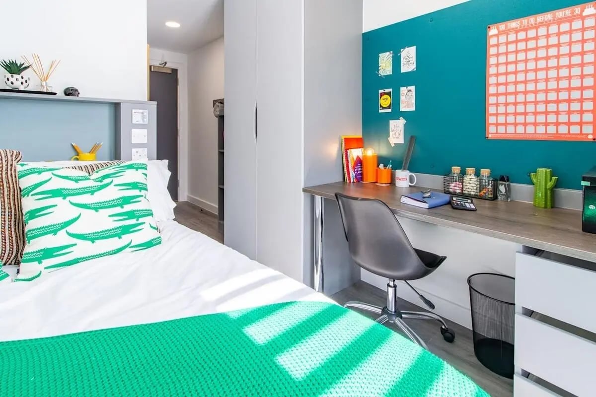 Bed with alligator pillow desk with chair and calendar Bedroom at The Gate in Sheffield Student Accommodation