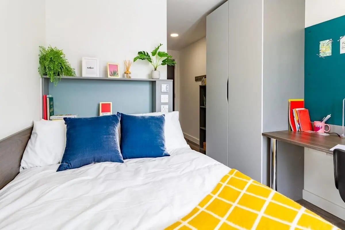 Bed pillows wardrobe desk books study area bedroom at The Gate in Sheffield Student Accommodation