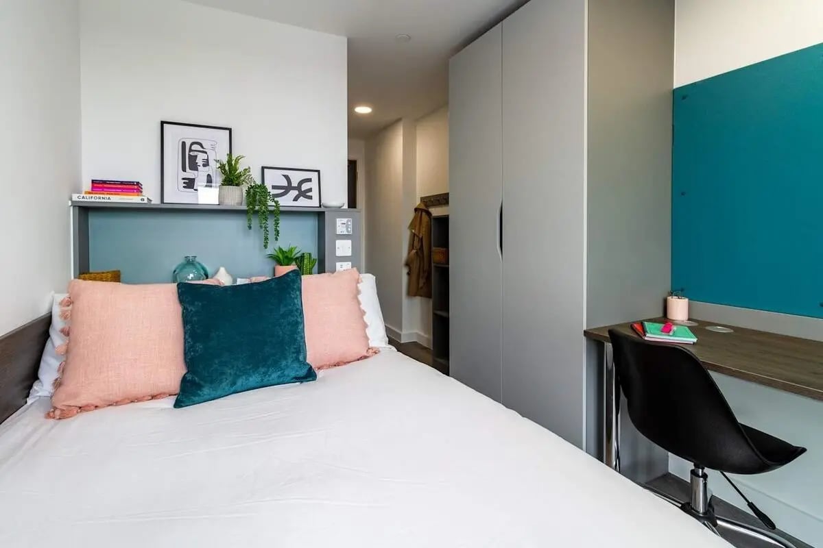 Bed with pillows desk and wardrobe bedroom at The Gate in Sheffield Student Accommodation