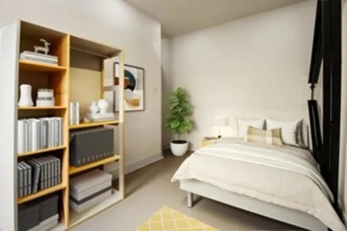 Bookshelf bed with plant and framed art Bedroom at The Old Fire Station - Birmingham in Birmingham Student Accommodation