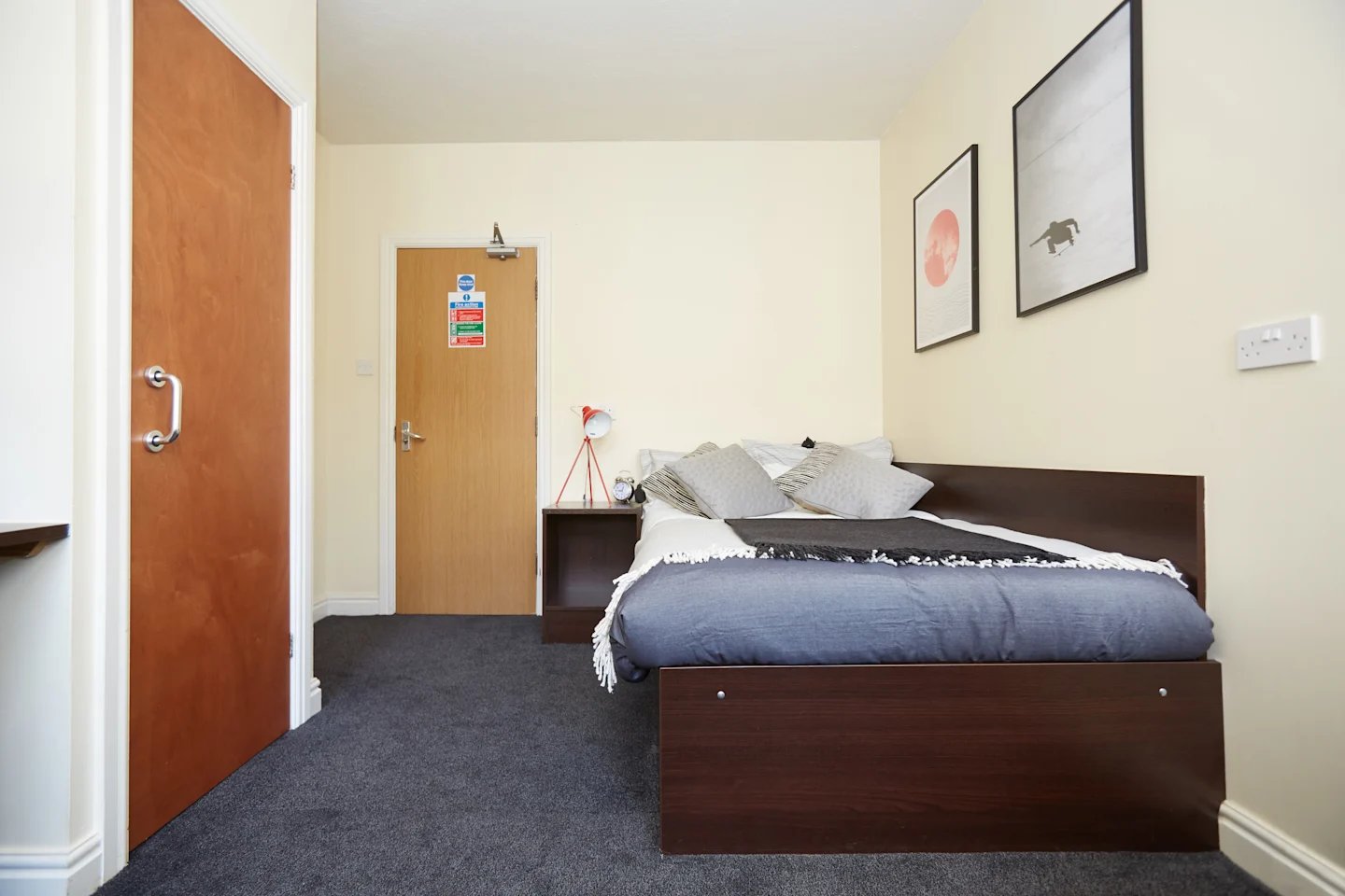Bed with pillows and dark grey blanket bedroom at Truro Sheffield in Sheffield Student Accommodation