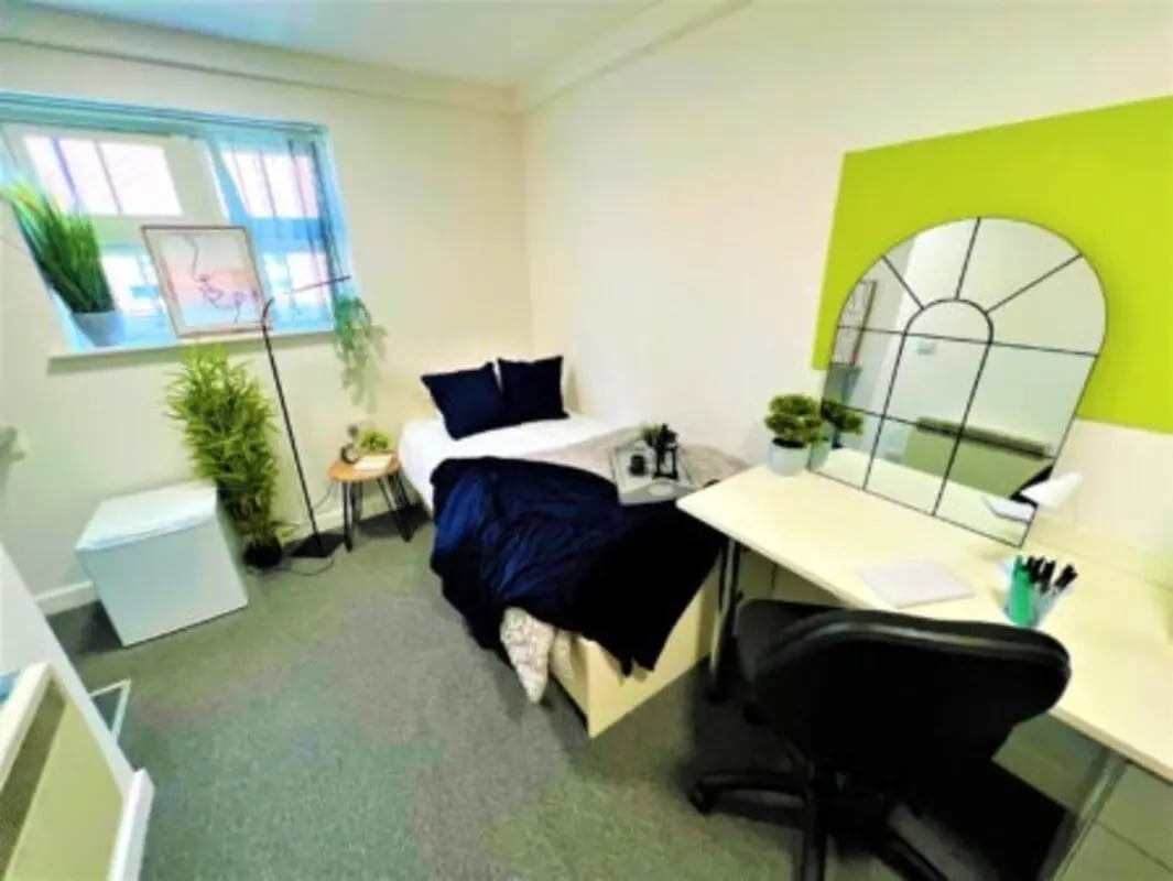 Bed desk mirror plants storage bedroom interior at Tudor Studios in Leicester Student Accommodation