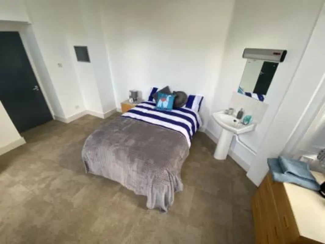 Bed sink and dresser in room bedroom at St Mary's Newcastle in Newcastle Upon Tyne Student Accommodation