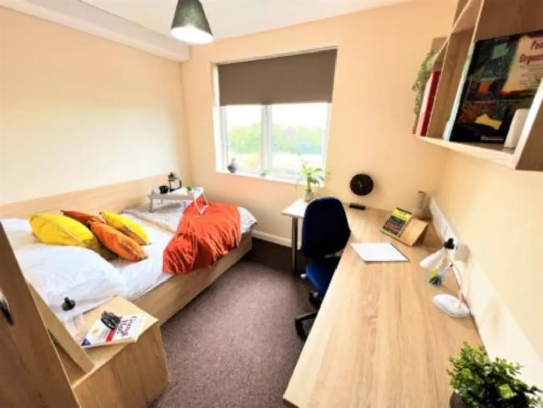 Bed desk chair pillows orange throw study Bedroom at Jubilee Court in Preston Student Accommodation