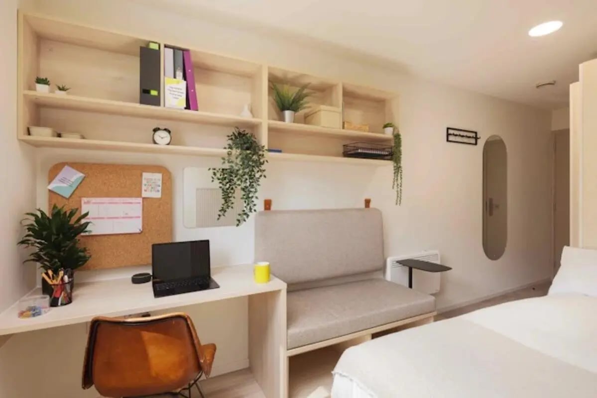Desk with laptop couch and shelves Bedroom at Buchanan View in Glasgow Student Accommodation