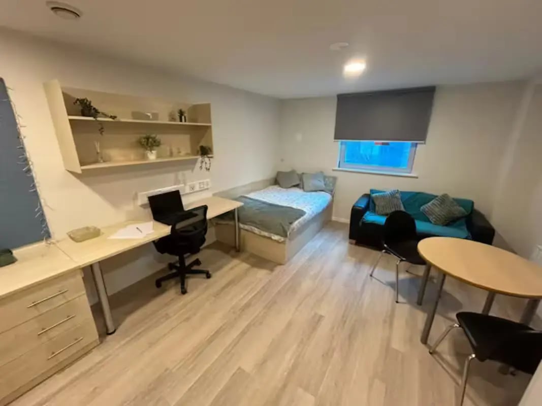 Bed desk sofa table and chair student room at Trinity Square in Nottingham Student Accommodation