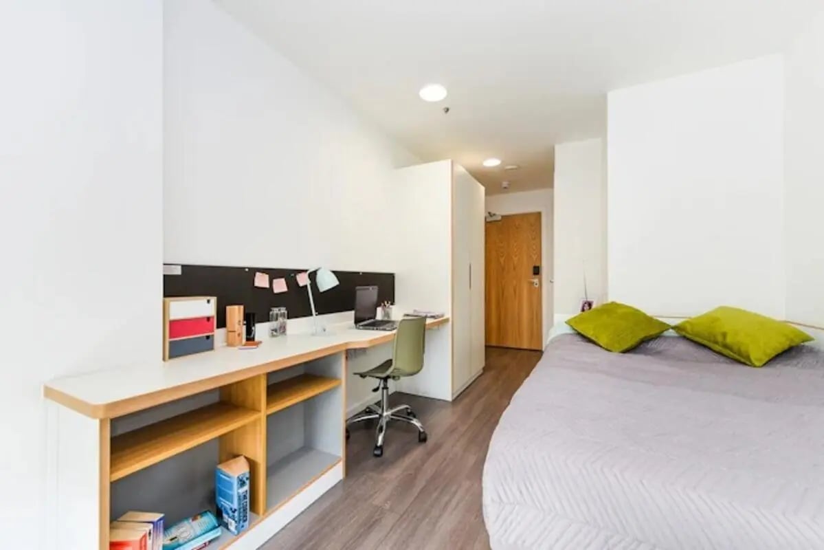 Bed desk chair and closet Student Room at Byrom Point in Liverpool Student Accommodation
