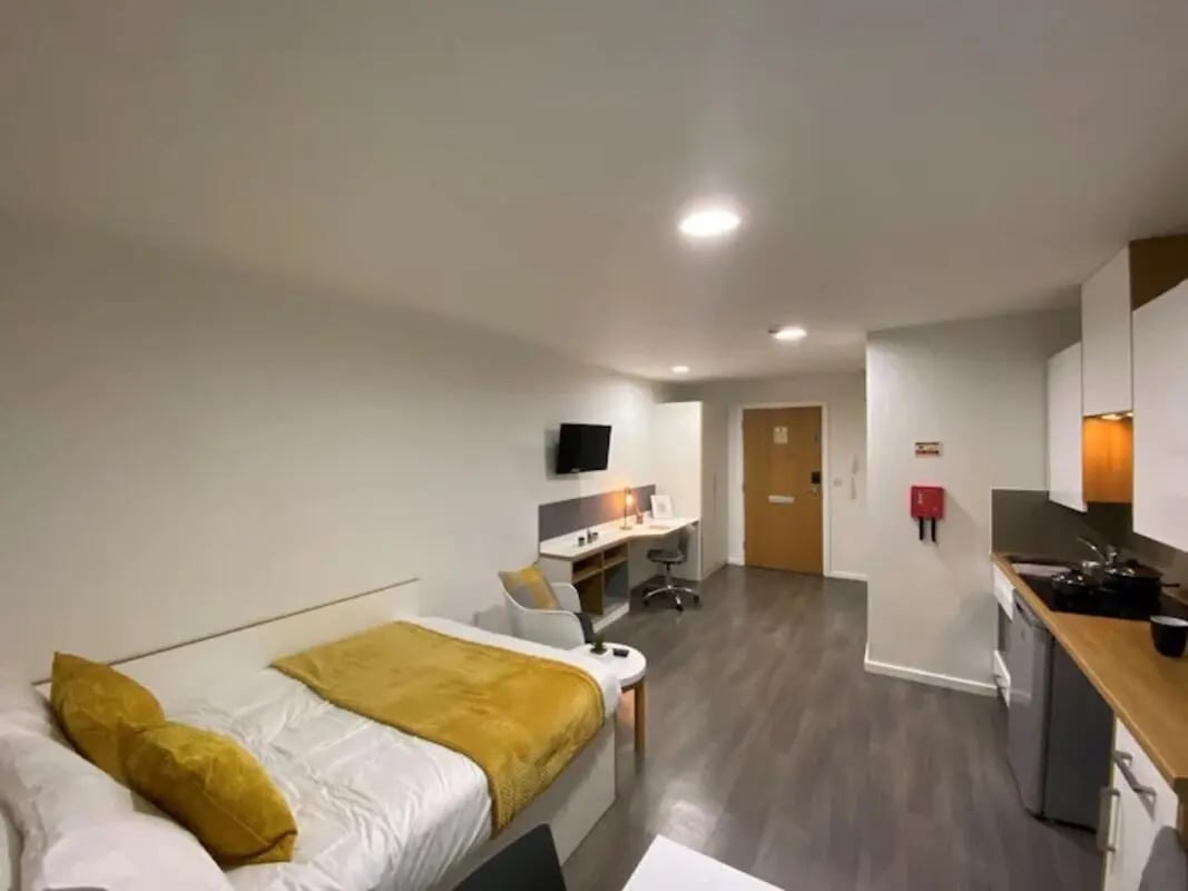 Bed desk kitchen and door studio apartment at Laycock Studios in Sheffield Student Accommodation