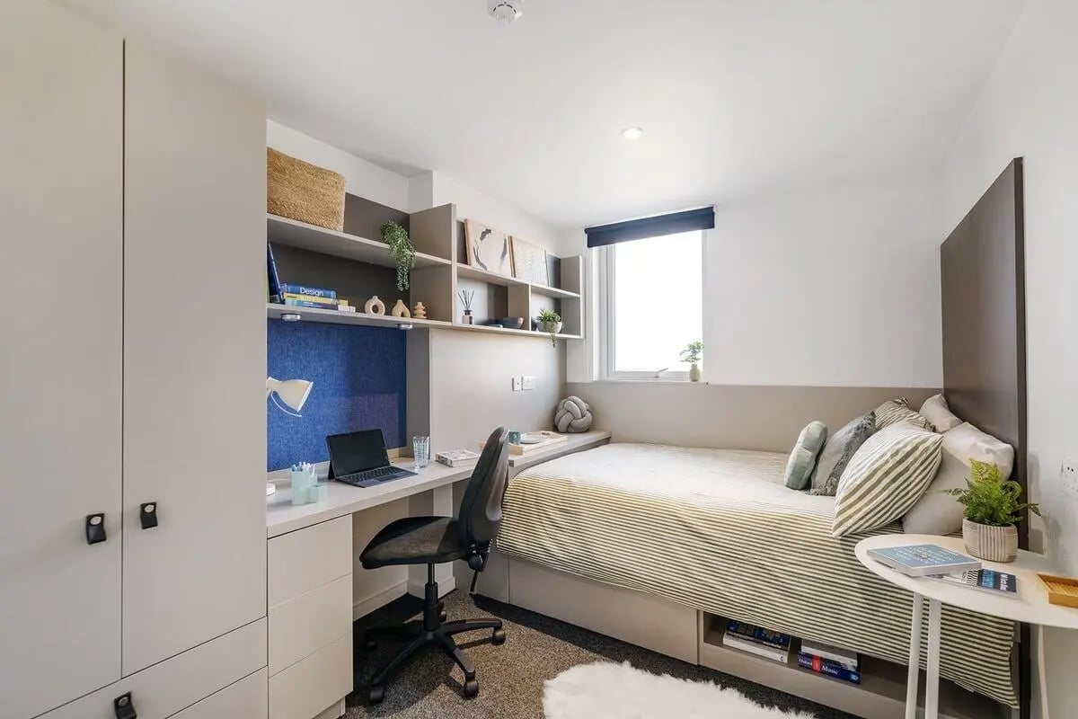 Bed desk chair shelves and wardrobe bedroom at Canvas Coventry City Point in Coventry Student Accommodation