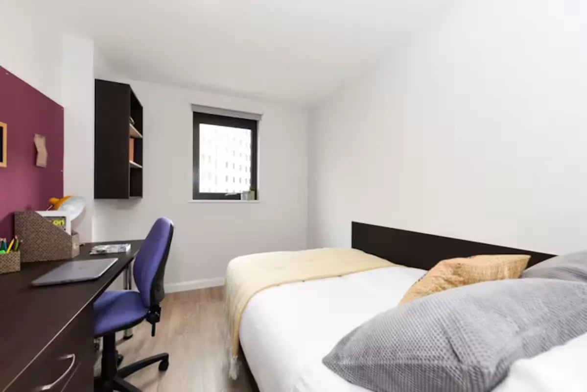 Desk chair laptop shelves bed and window bedroom at St Davids in Swansea Student Accommodation