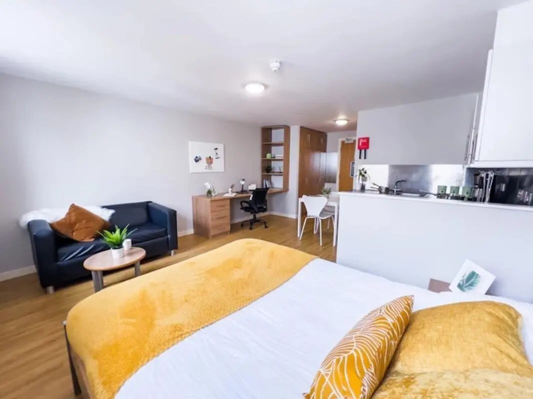 Bed sofa desk kitchen and seating living area at Panmure Court in Edinburgh Student Accommodation