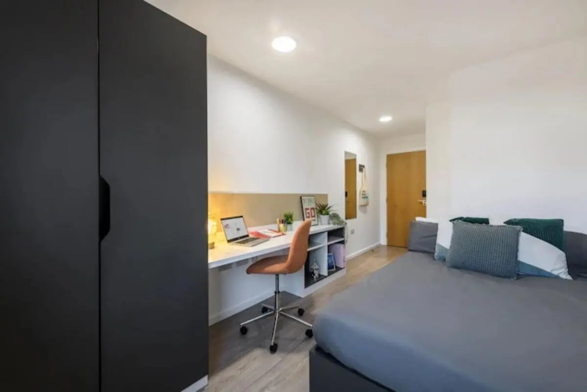 Dark wardrobe desk chair bed student bedroom at The Towpath in Chester Student Accommodation