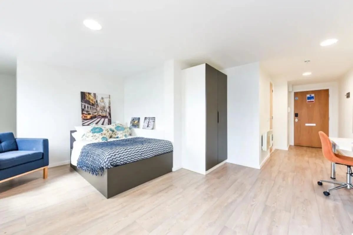 Blue sofa bed closet wooden floor and door bedroom at The Towpath in Chester Student Accommodation