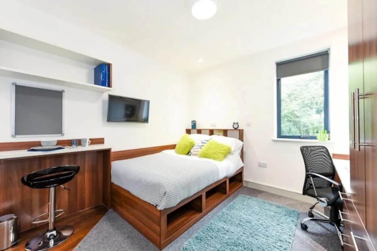 Bed desk chair and TV bedroom at Chapel Heights in Durham Student Accommodation