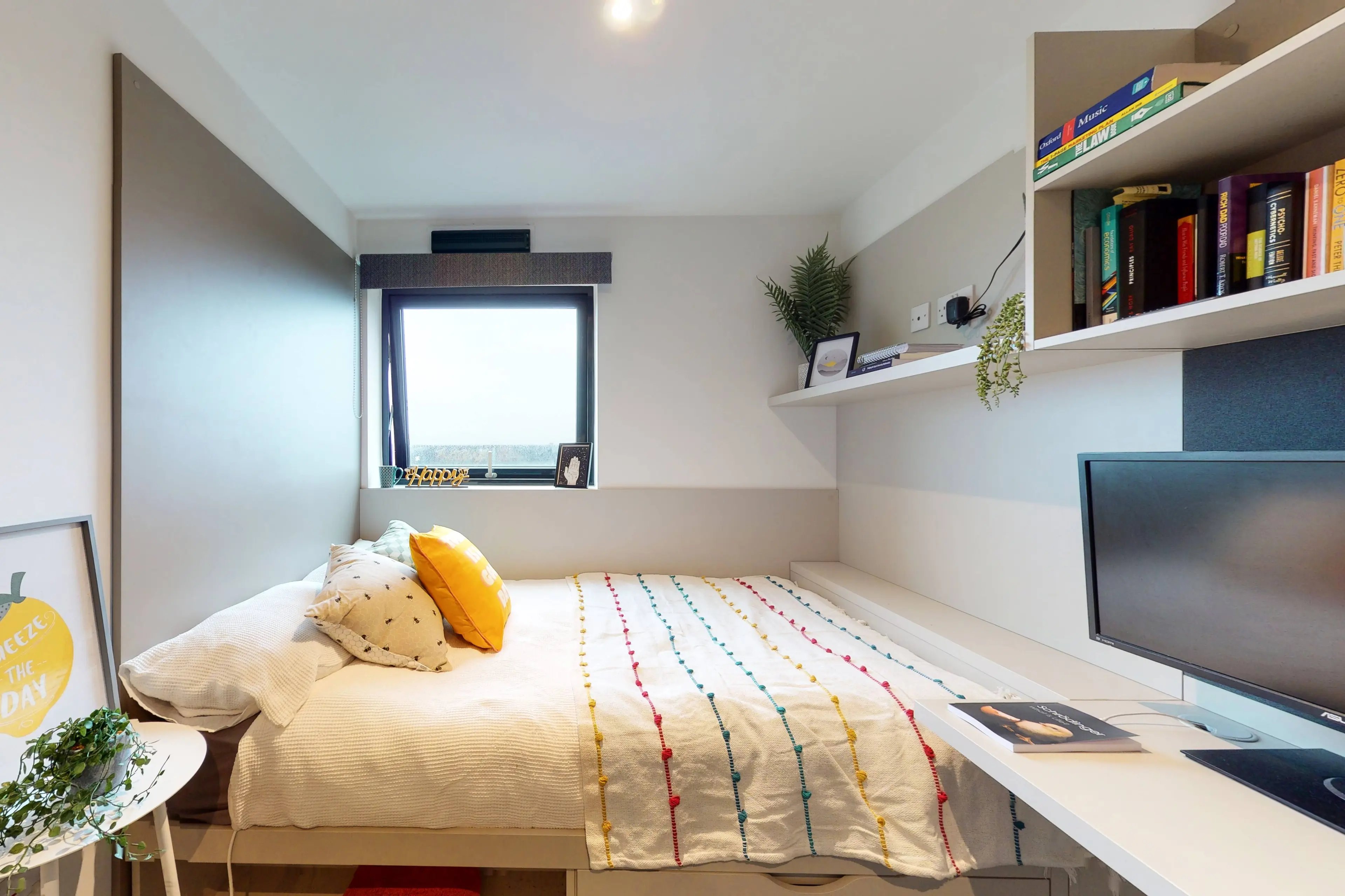 Bed with pillows and blanket desk computer bedroom at Canvas Manchester in Manchester Student Accommodation
