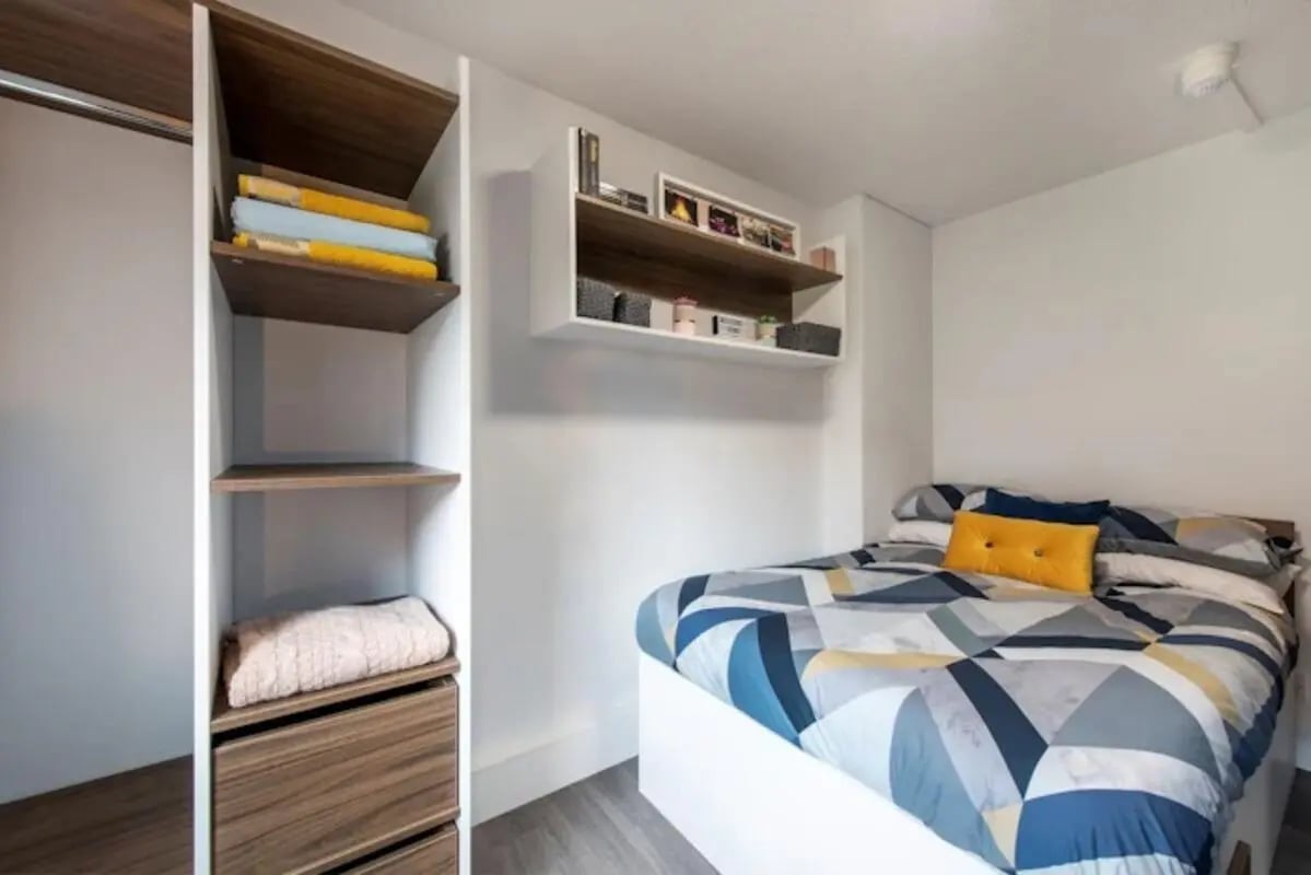 Shelves bed with patterned bedding and pillows bedroom at Regents Court in Leicester Student Accommodation