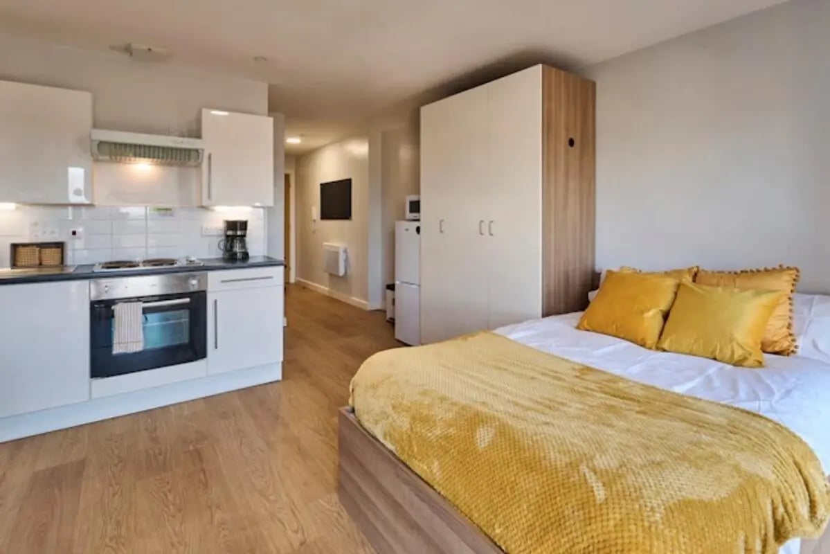 Bed kitchen wardrobe and fridge studio apartment at The Summit Leicester in Leicester Student Accommodation