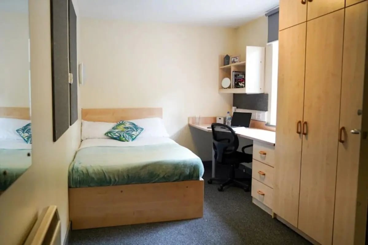 Bed desk wardrobe and shelving bedroom at Regents Court in Leicester Student Accommodation