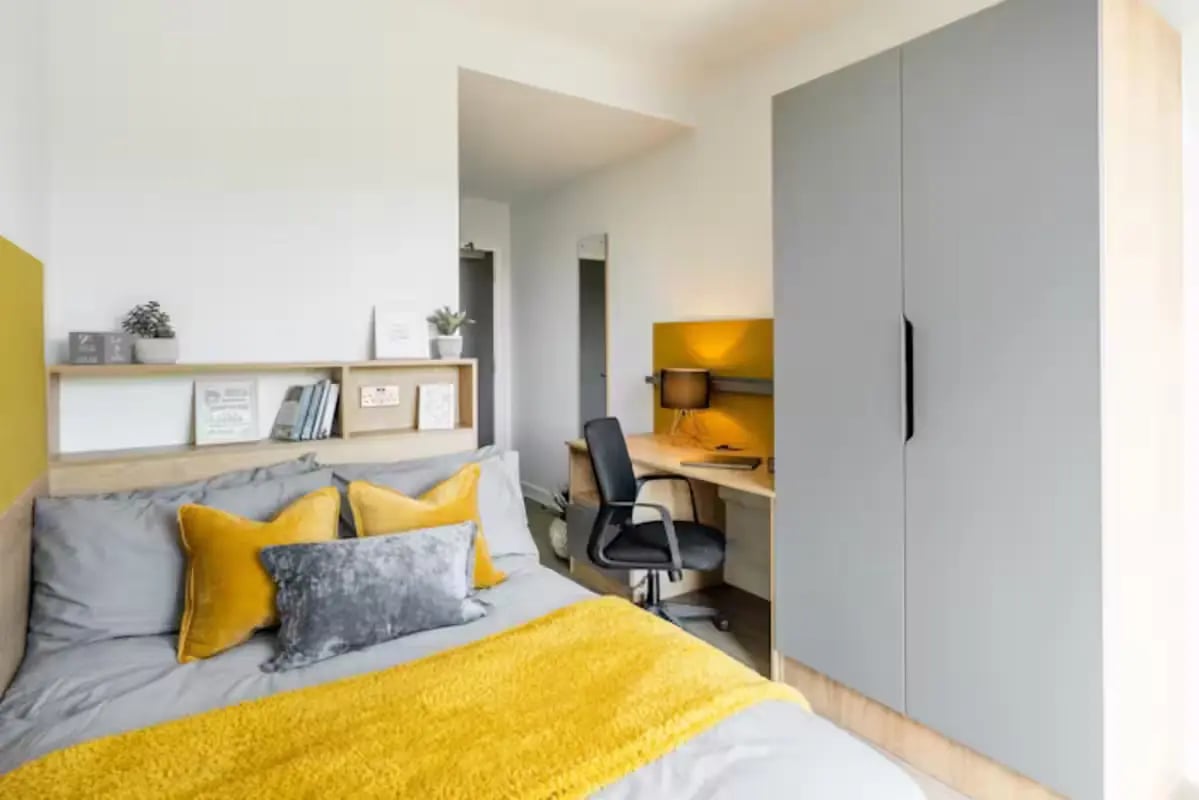 Bed desk wardrobe and shelving student bedroom at Hillfort House in Brighton Student Accommodation