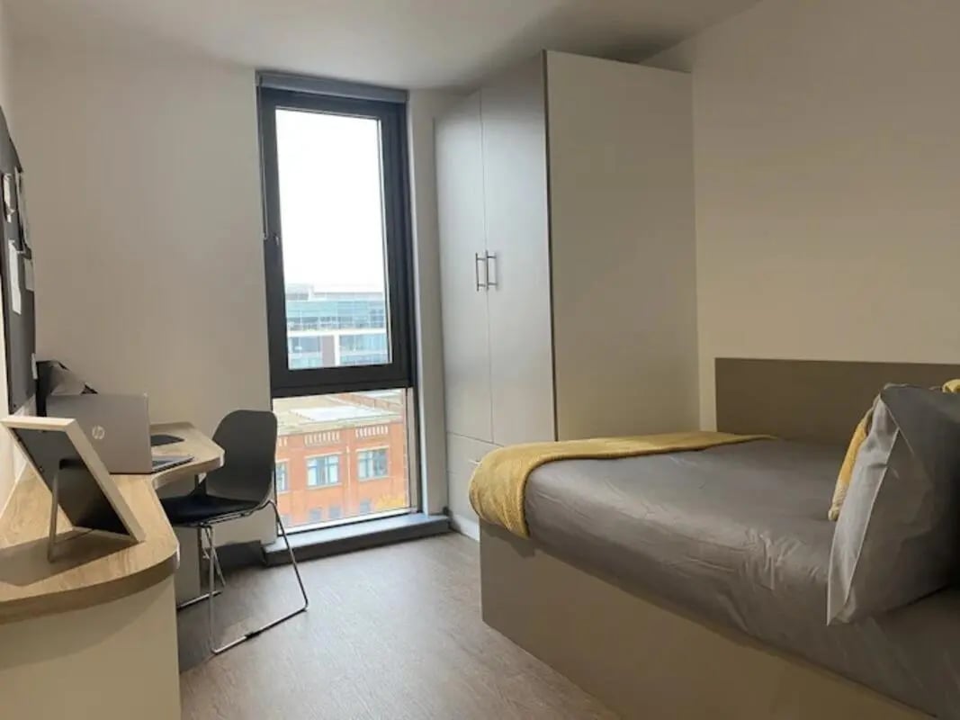 Desk laptop chair wardrobe bed bedroom at Great Patrick Street in Belfast Student Accommodation