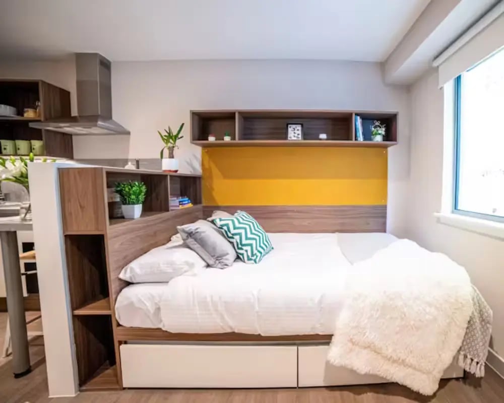 Bed pillows shelves and blanket bedroom at Brewer's Court in Edinburgh Student Accommodation