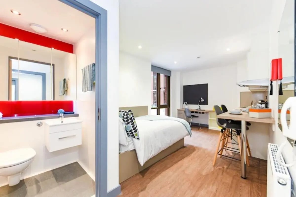 Bed desk table and bathroom studio apartment at Great Patrick Street in Belfast Student Accommodation