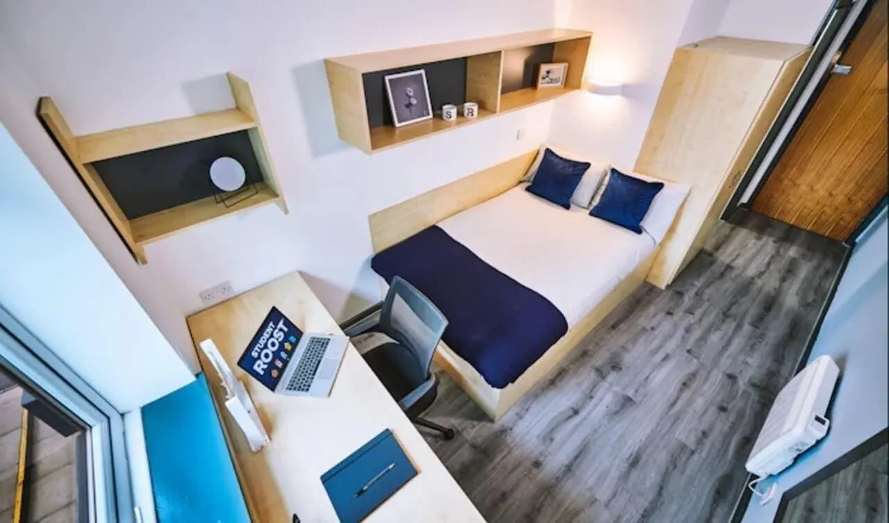 Bed desk chair shelves and closet bedroom at Capital Gate in Liverpool Student Accommodation