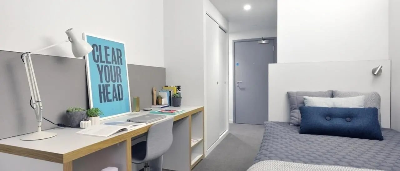 Desk lamp laptop and bed bedroom at Victoria Hall Kings Cross in London Student Accommodation