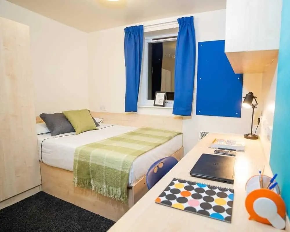 Bed desk closet window blue curtains bedroom at Queen's Hospital Close in Birmingham Student Accommodation