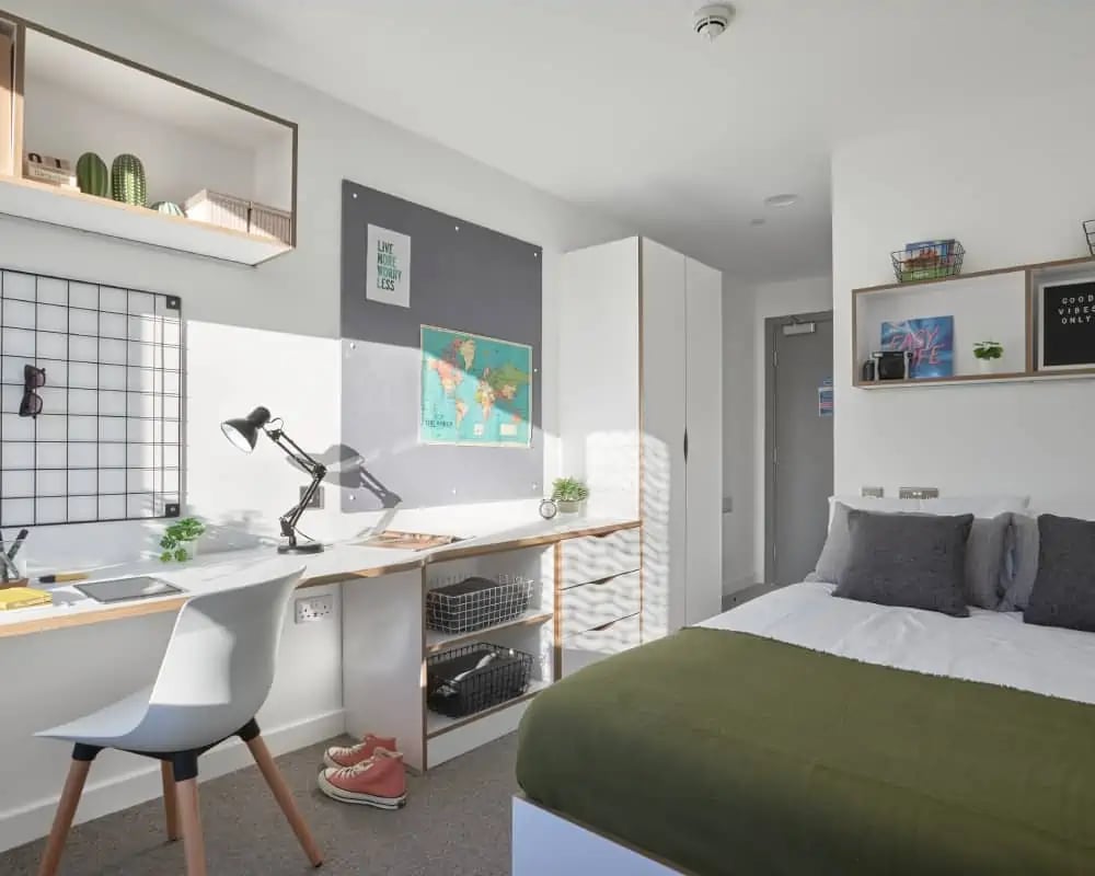 Desk chair lamp bed with green blanket Bedroom at 41 Castle Street in Leicester Student Accommodation